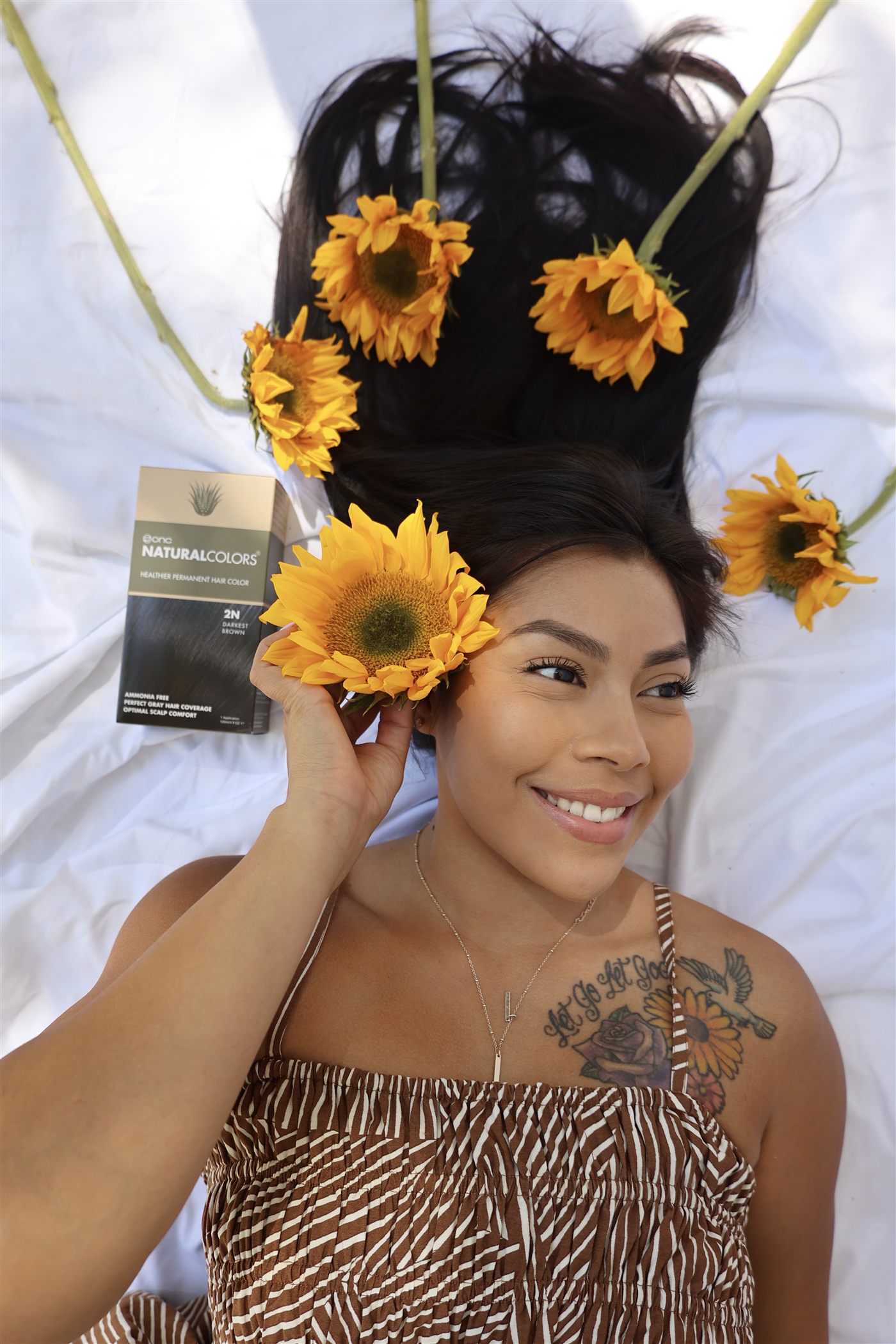 Smiling model surrounded by sunflowers